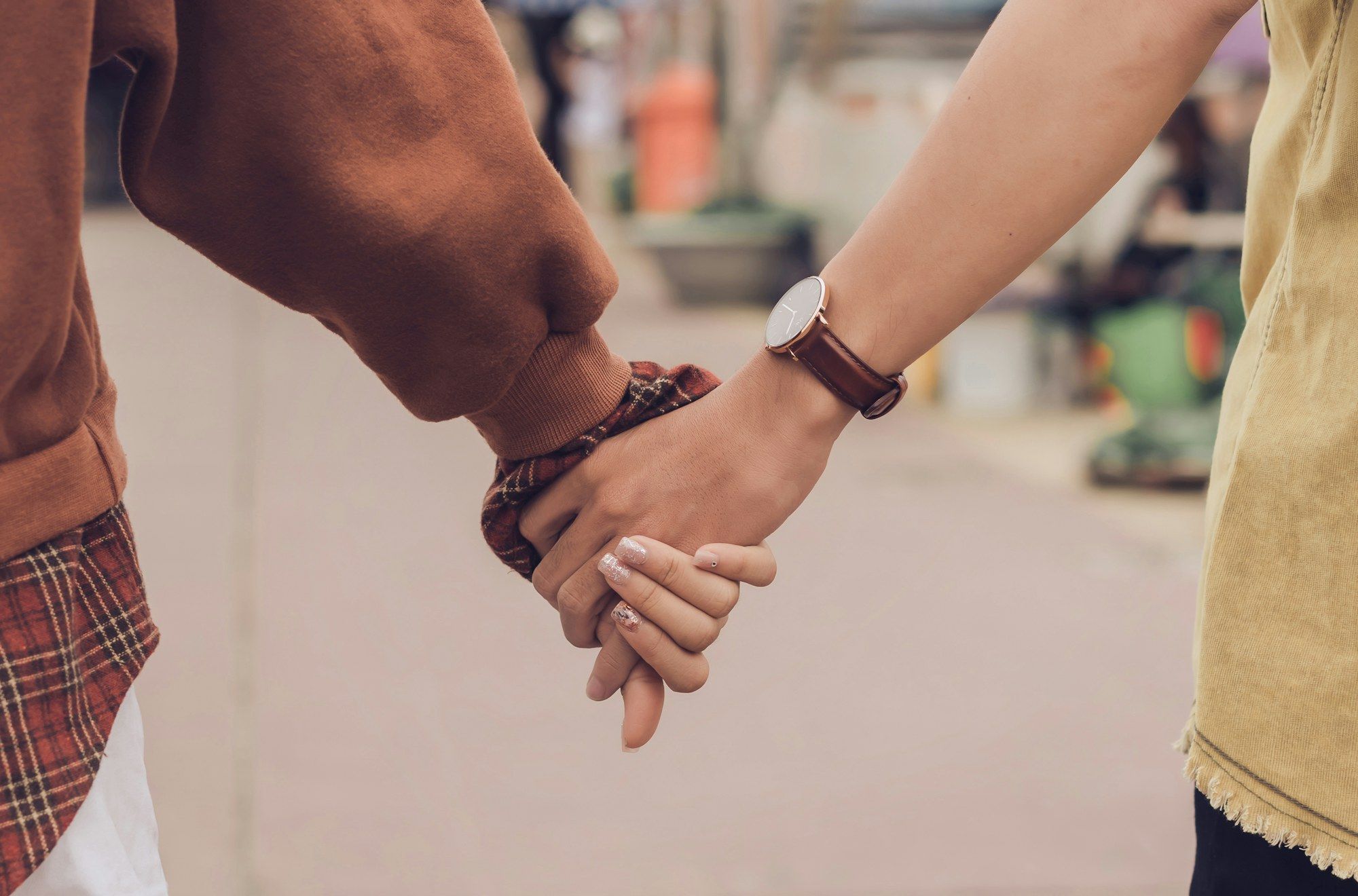 Two people walking hand in hand